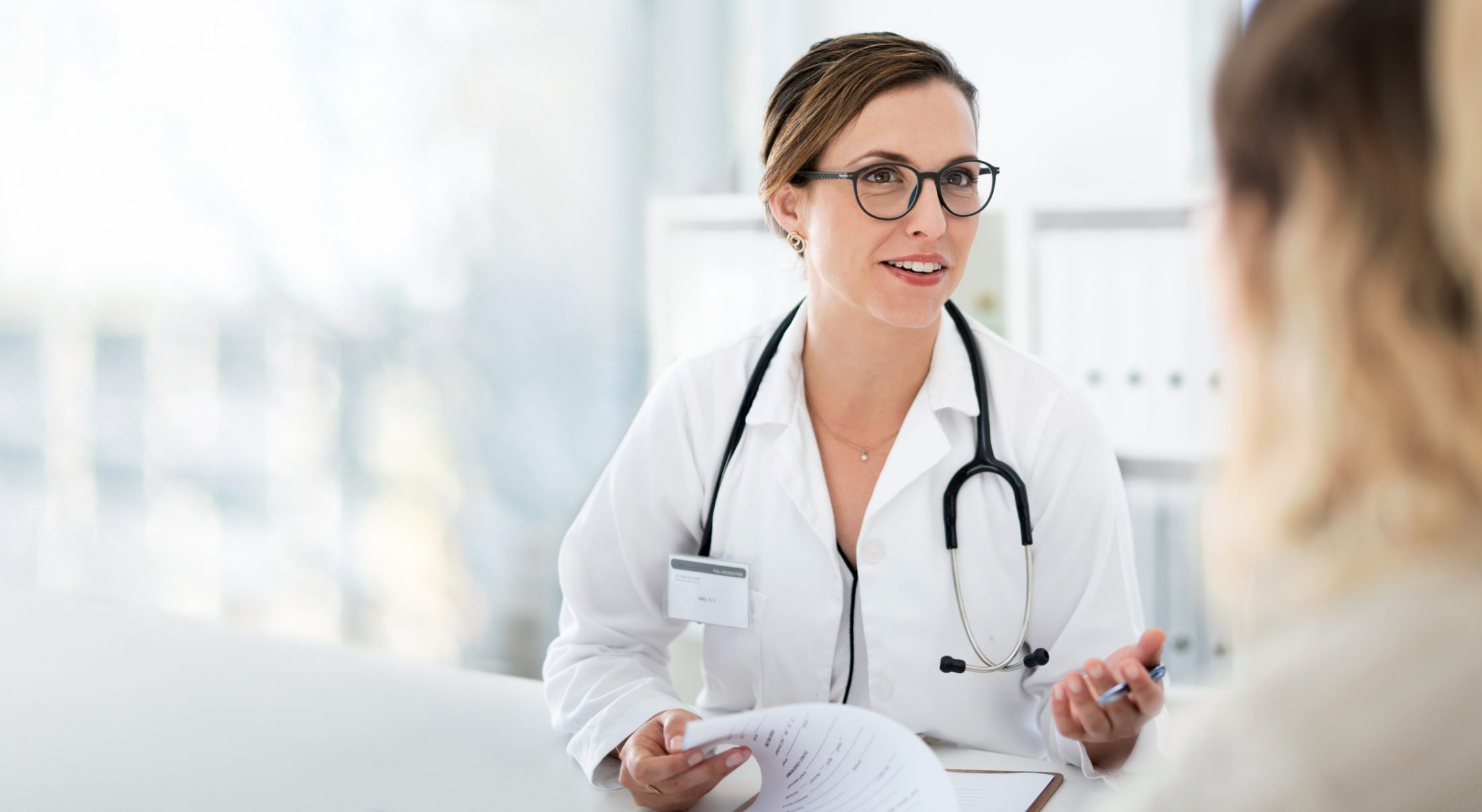 female doctor talking to female patient