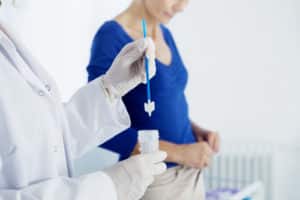 Gynecologist working for vaginal and cervix pap smear patient